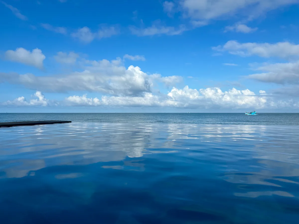 Saltwater infinity pool merging with the ocean at Camia Resort & Spa Phu Quoc
