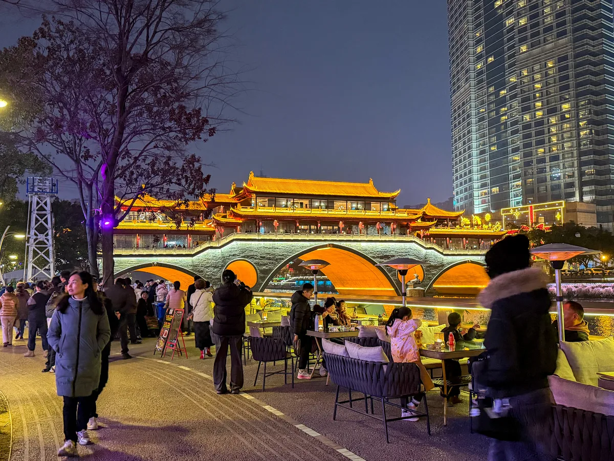 Riverside seating with a night view of Anshunlang Bridge in Chengdu