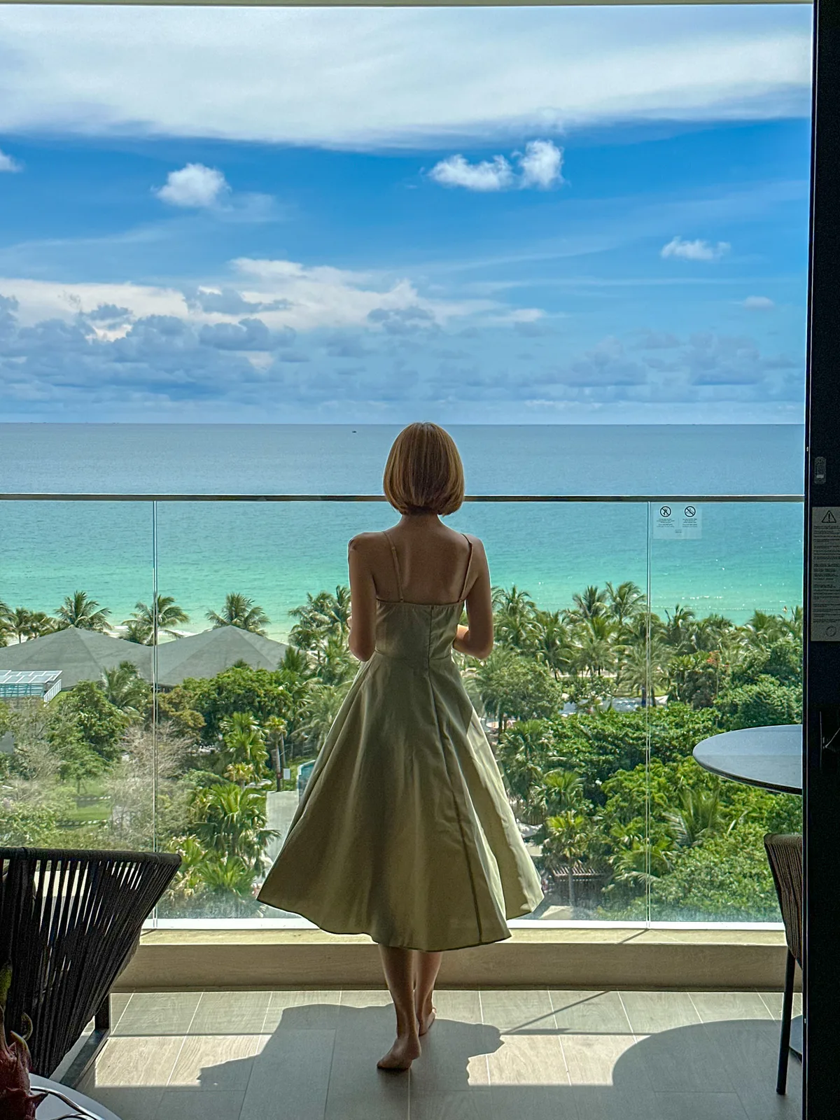 Guest standing on the balcony overlooking the ocean at Crowne Plaza Phu Quoc