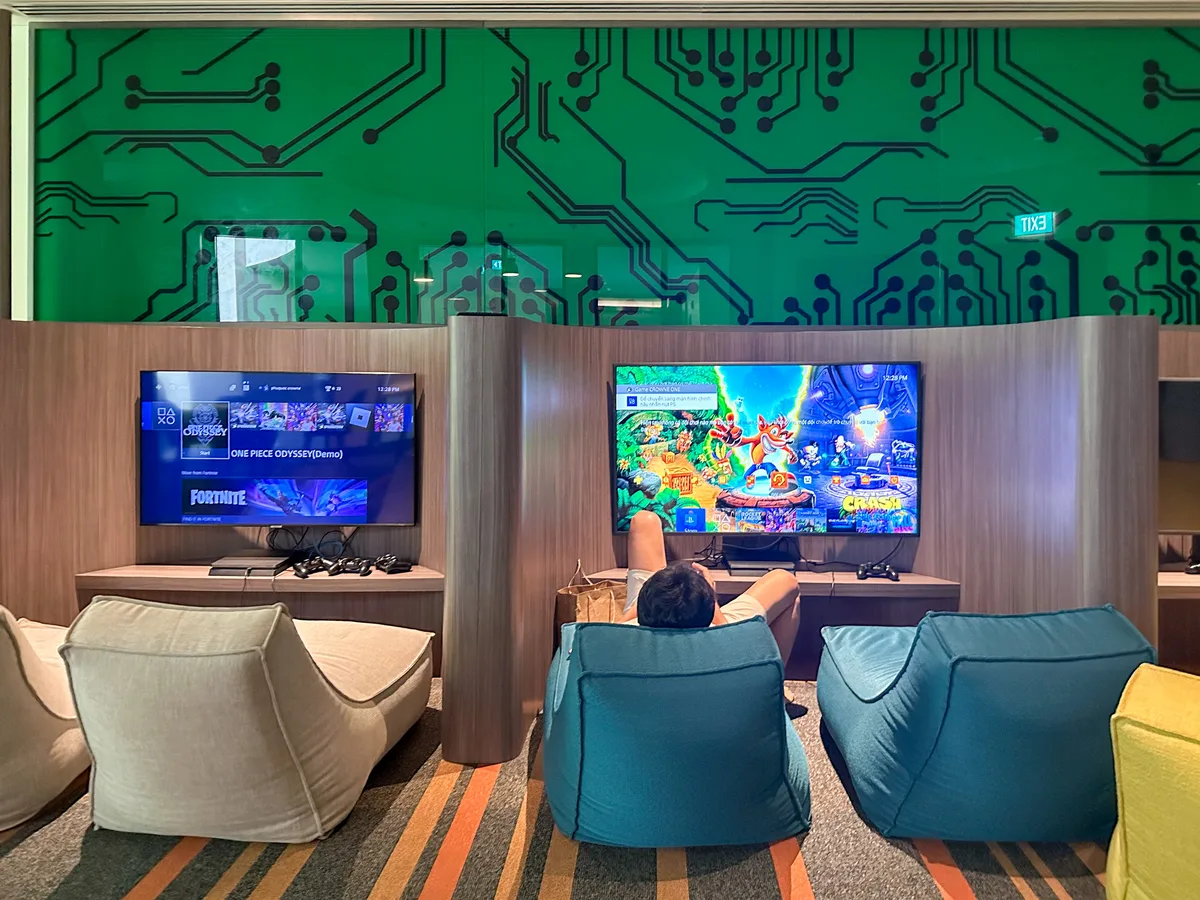 Game room with circuit-board wallpaper and PlayStation setup at Crowne Plaza Phu Quoc