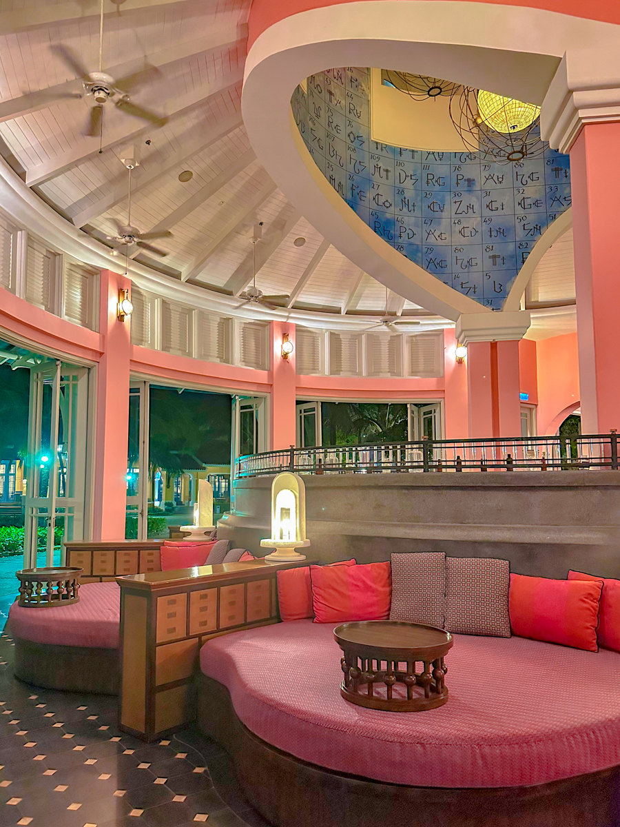 Pink interior with a periodic table ceiling and curved lounge seating at D.O.C Bar, JW Marriott Phu Quoc