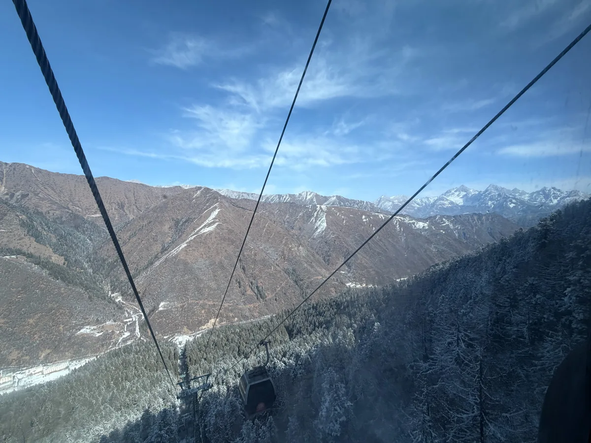 Cable car view of snow-covered mountains at Huanglong in winter