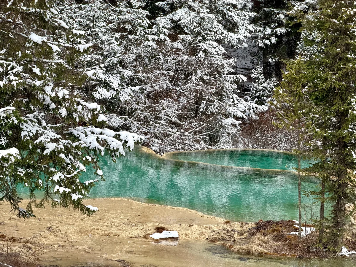 Terraced pools near Yingbin Pond, partly frozen, on the Huanglong descent