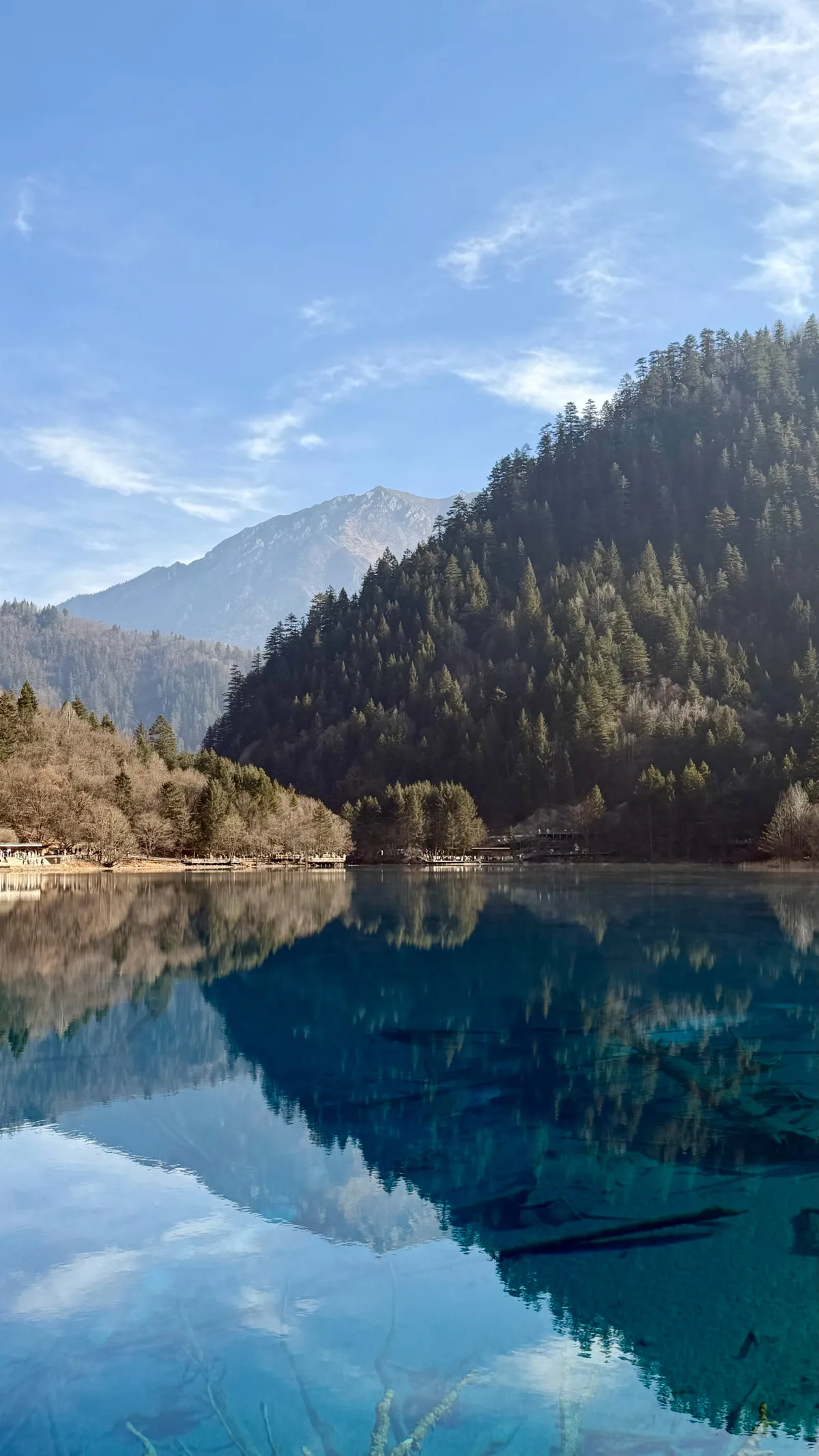 A deep blue Jiuzhaigou lake in winter, showing how different the park looks by season