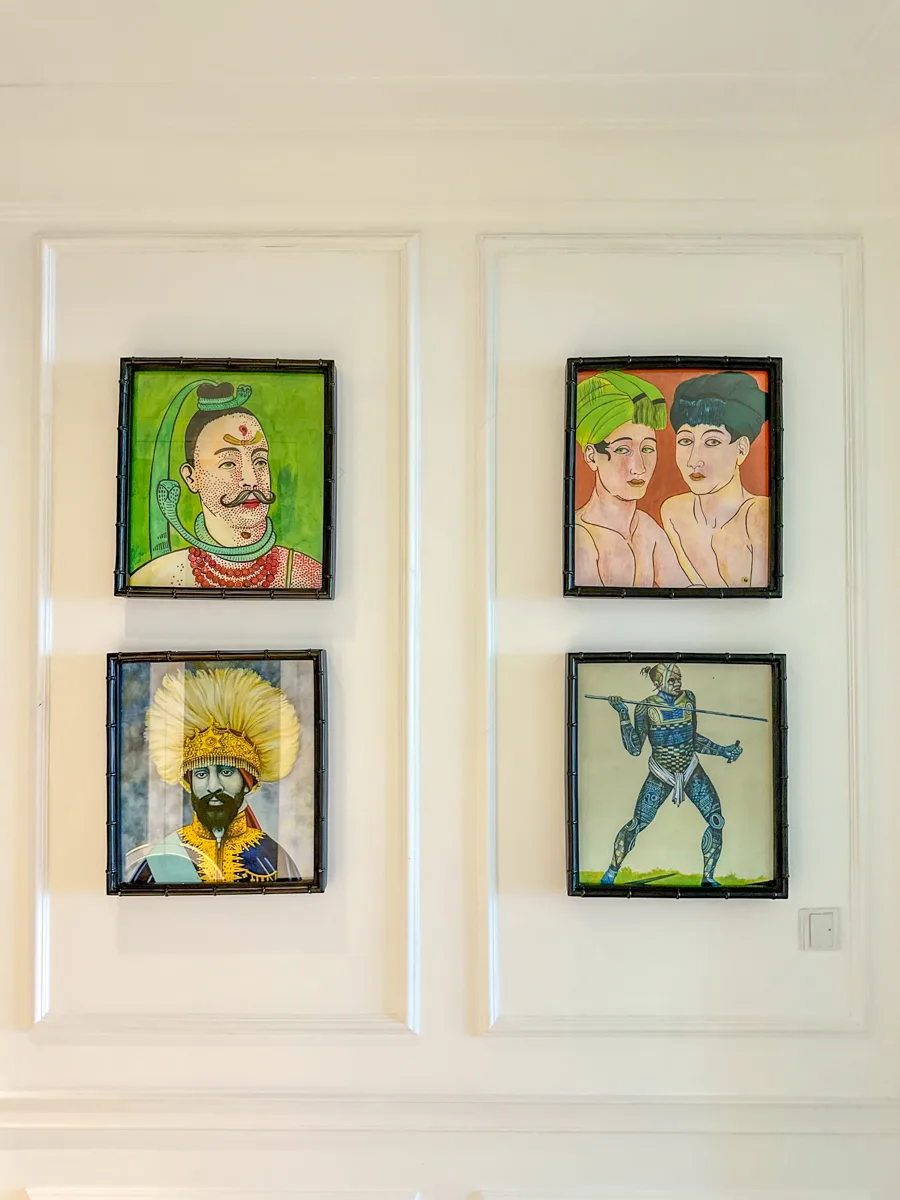 Bamboo-framed tribal portrait illustrations on the wall of an Anthropology-building room at JW Marriott Phu Quoc