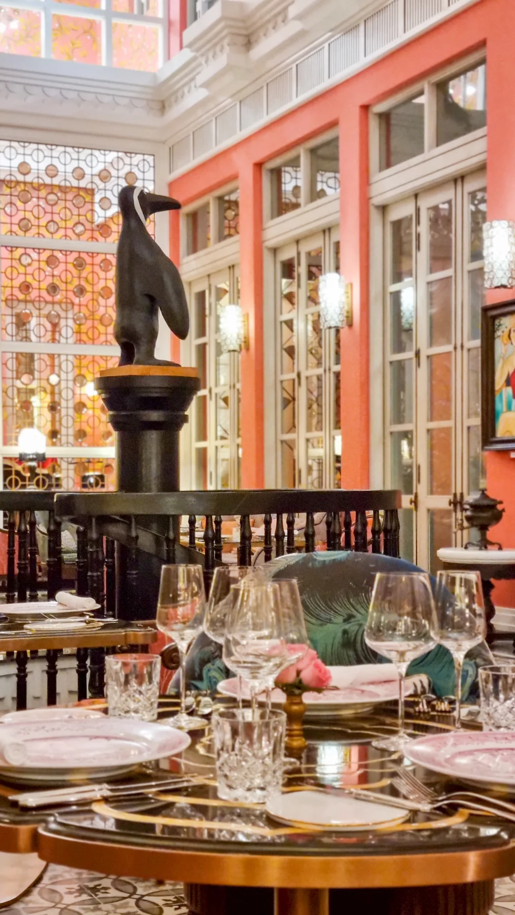 Pink dining room with a penguin sculpture at Pink Pearl, JW Marriott Phu Quoc