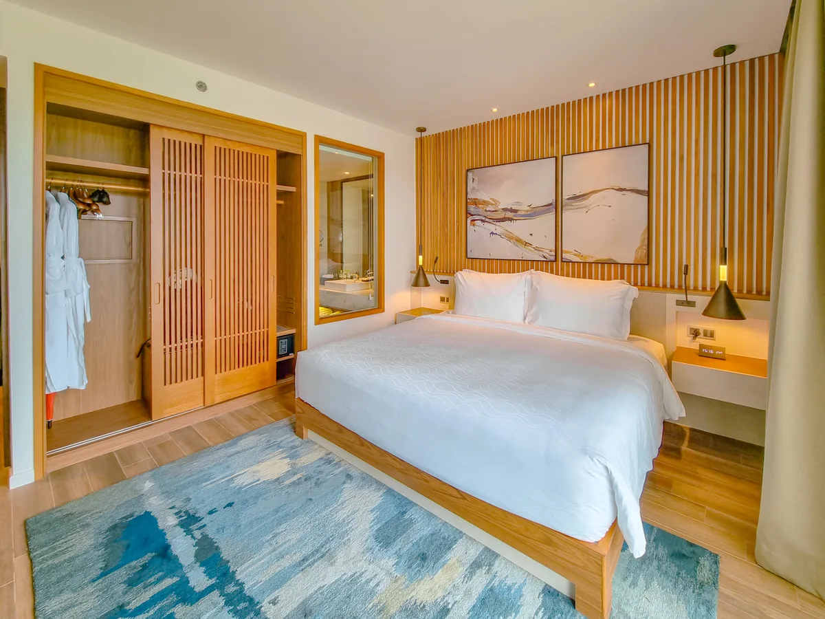 King bedroom with wood interior at Movenpick Resort Waverly Phu Quoc residence