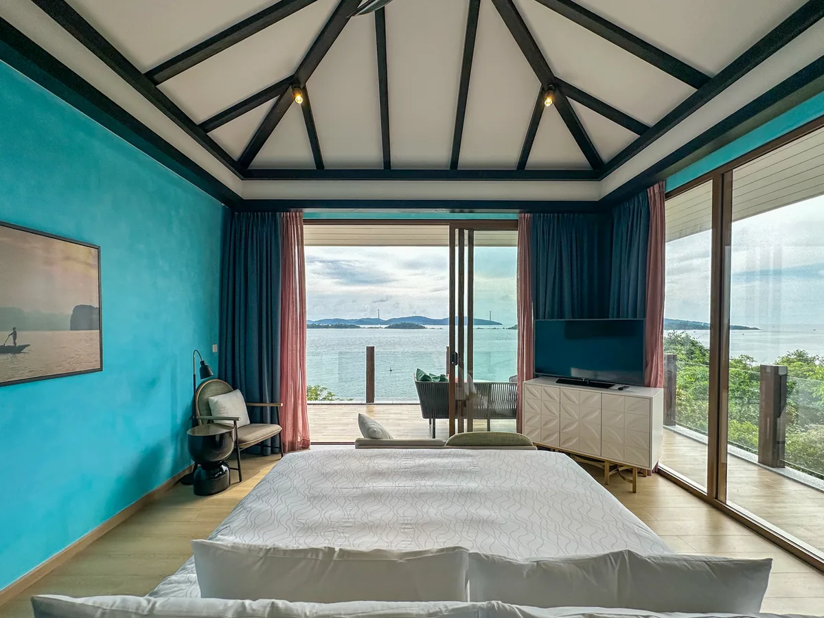 Living room with bicycle-wheel wall art and colorful rugs in an Eden Retreat Villa at Premier Village Phu Quoc