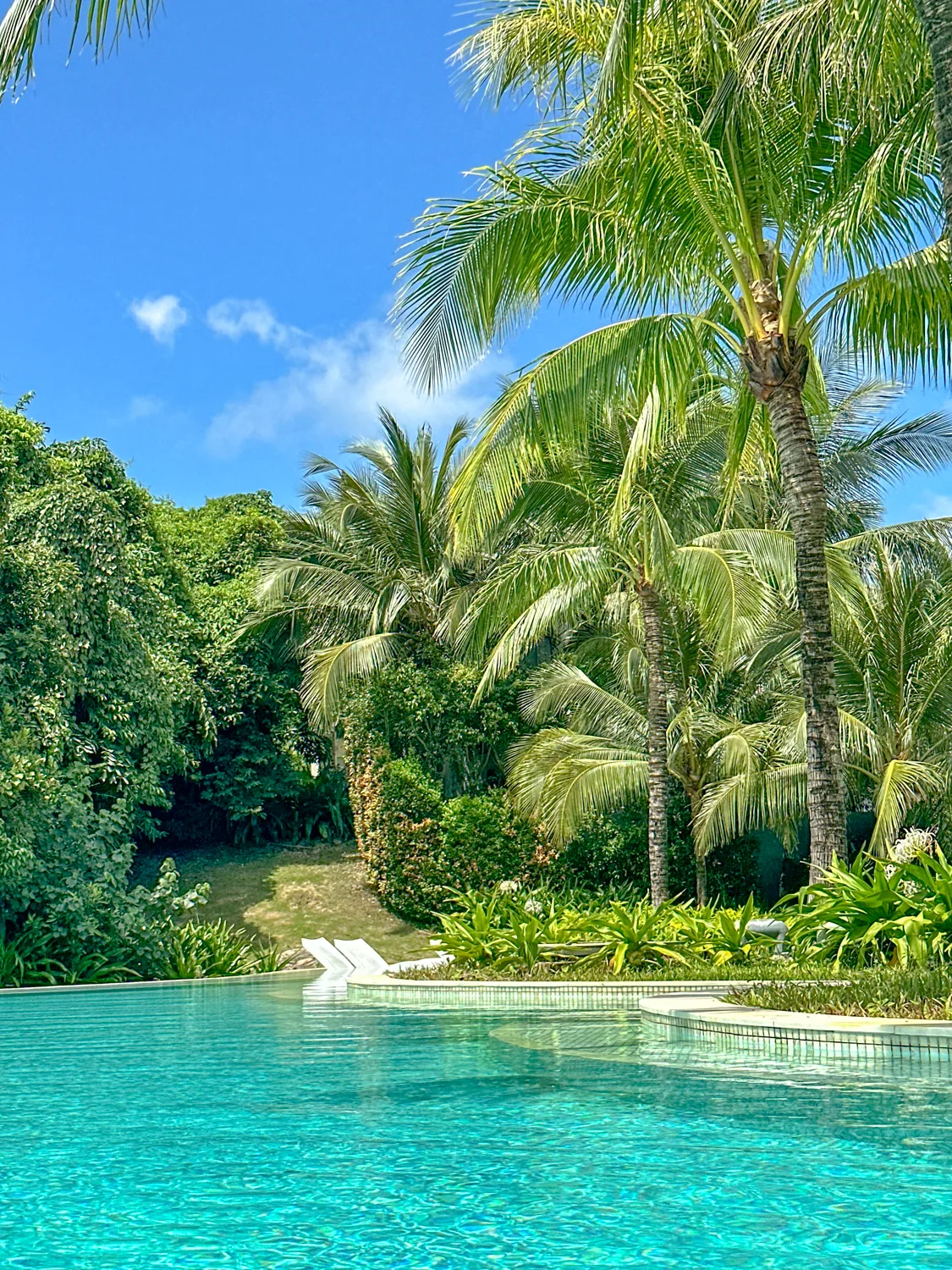 Main pool with a thatched-roof pool bar and beach view at Premier Village Phu Quoc