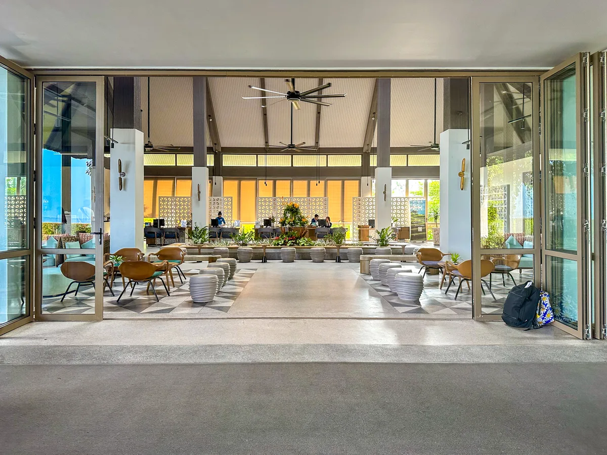 Open-air reception desk with folding glass doors at Premier Village Phu Quoc