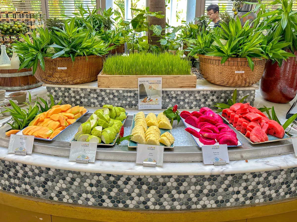 Tropical fruit station with papaya, guava, pineapple, dragon fruit, and watermelon at The Market restaurant