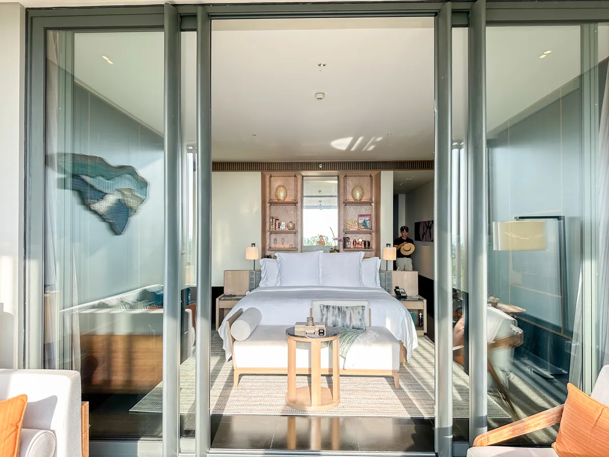 Bedroom with mountain-shaped wall art in an Ocean View Suite at Regent Phu Quoc