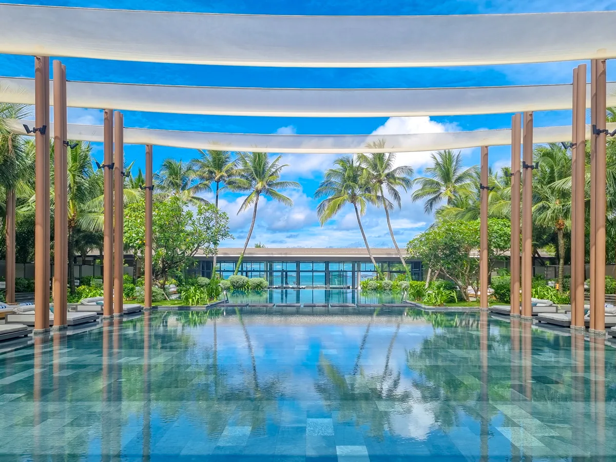 Daytime view of the pergola-covered infinity pool at Regent Phu Quoc