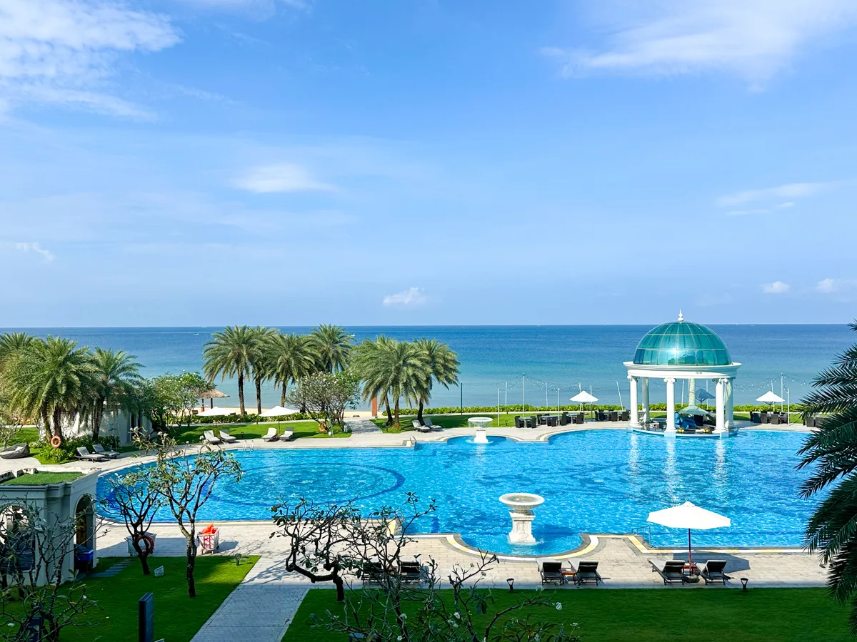 Aerial view of the Sheraton Phu Quoc main pool with domed pool bar and ocean beyond