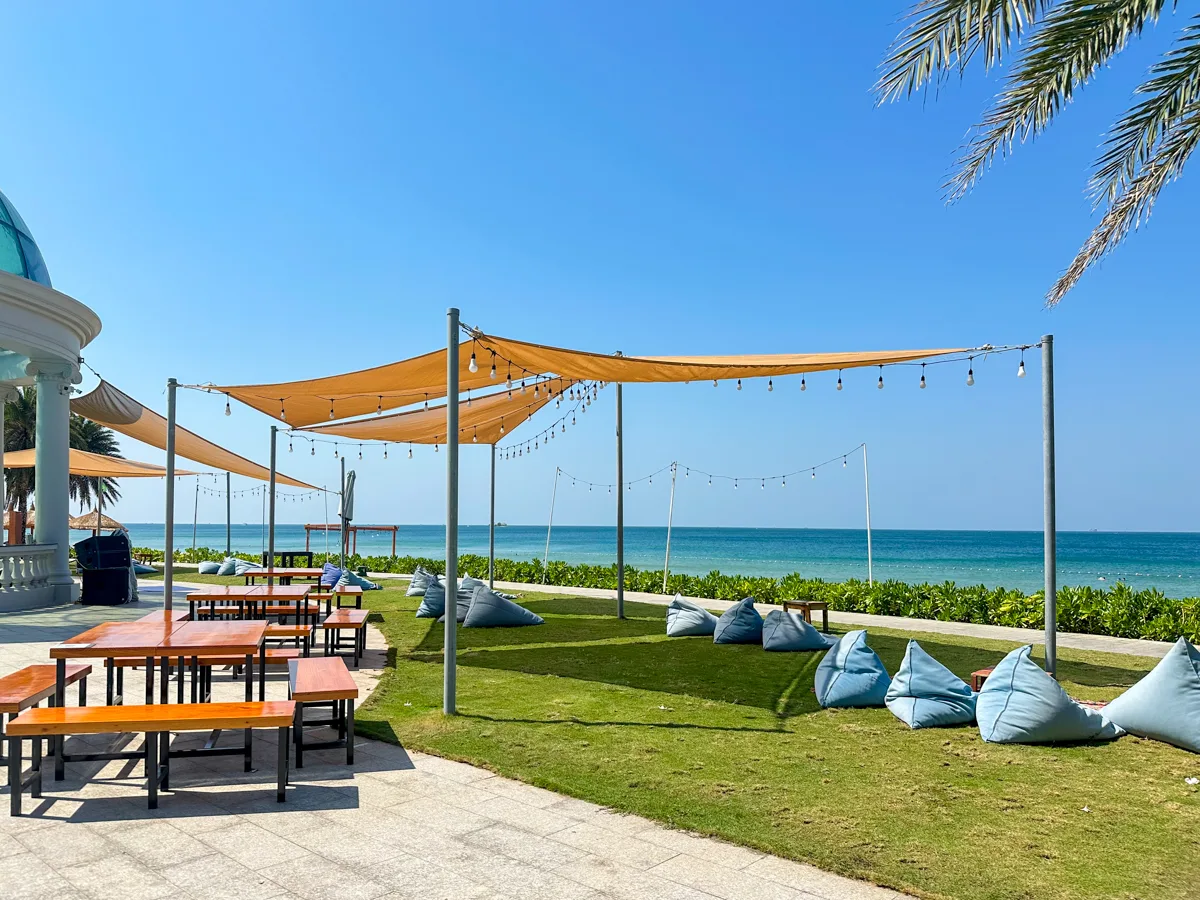 Beachfront lounge area with shade sails and bean bags at Sheraton Phu Quoc