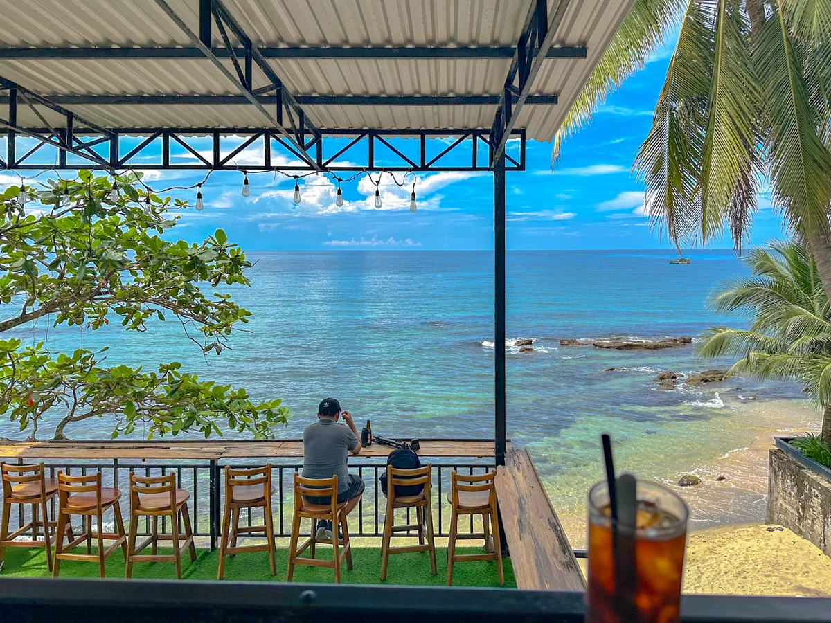 Someone sitting alone at an oceanview cafe in Phu Quoc looking out at the water