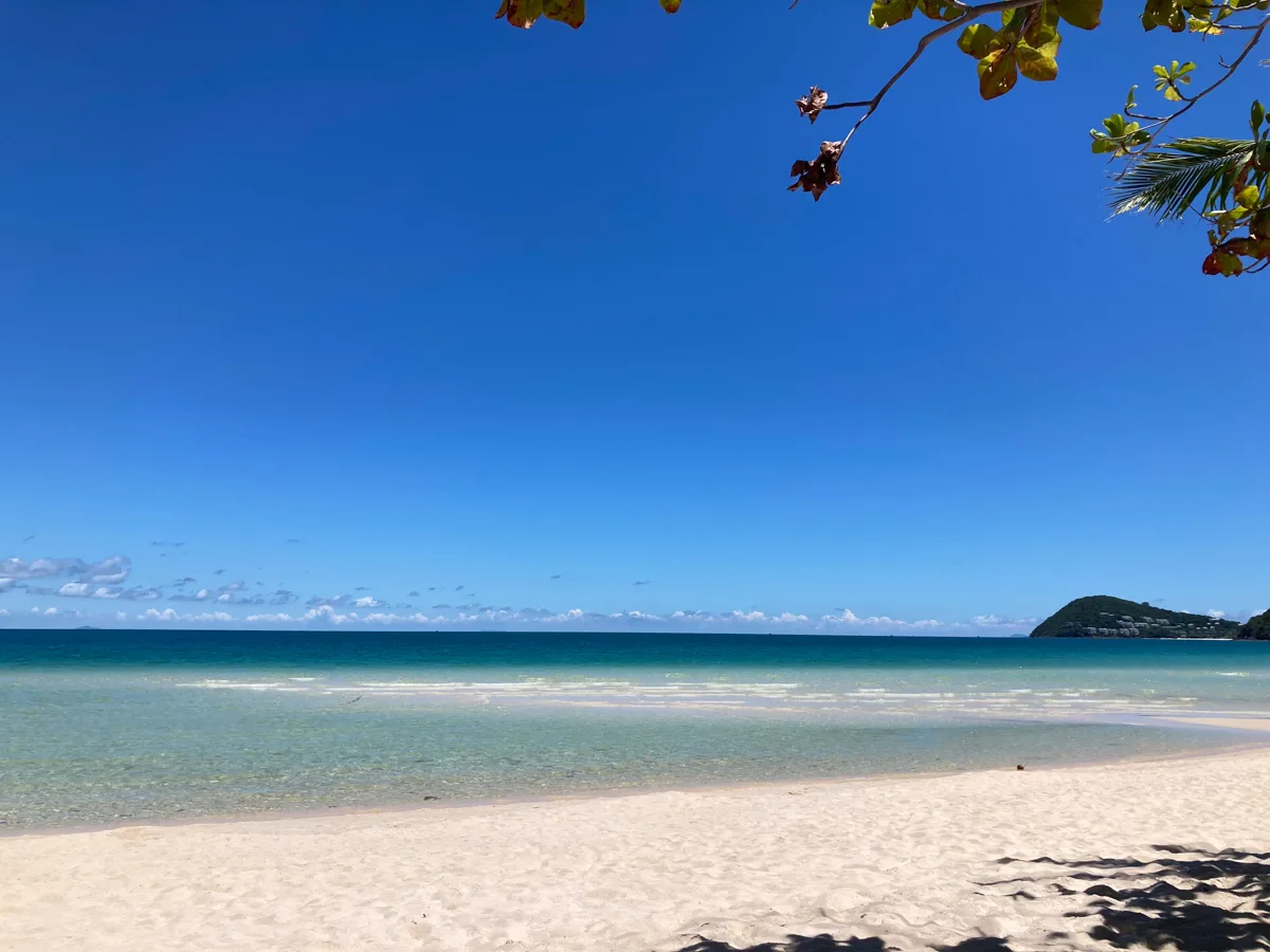Empty stretch of Phu Quoc beach looking out at emerald water in May-June