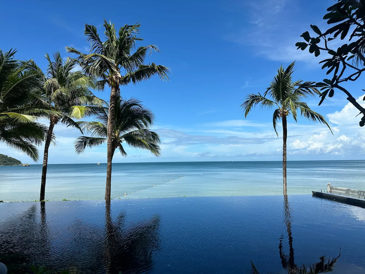 Clear sky after a shower with palm trees and an infinity pool on Phu Quoc